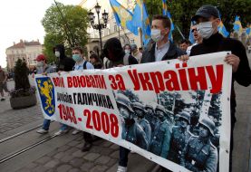 Молоді люди несуть плакат