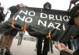 Participants of demostration burn a placard