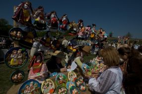 A woman sells clay souvenirs