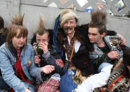 A cossack sits next to pans