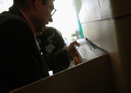 A guard takes out the sealed container