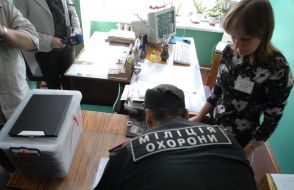 A guard takes out the sealed container