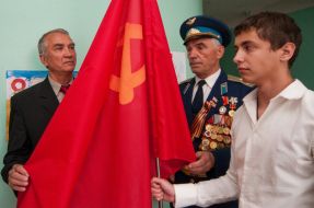 Aleksey Baburin passes a Soviet flag