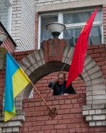A man places a Soviet flag
