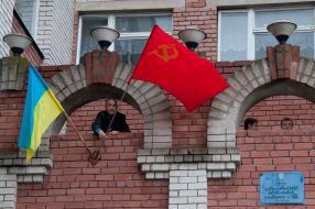 A man places a Soviet flag