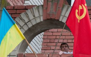 A boy places a Soviet flag