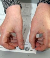 An instructor glues on a stroke-code