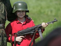 A boy in the Wehrmacht fighter helmet