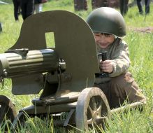 A boy ”shoots” from a machine gun