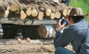 A photographer takes pictures a boy