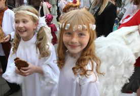Festive parade children-participants are in the suits of angels