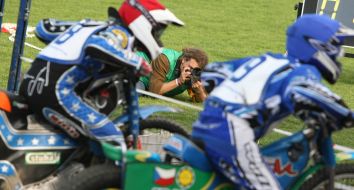 A photographer takes pictures European championship on speedway participants