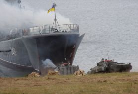 Fighting machines of infantry drives out from a large landing ship