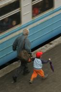 Man with a child hurry on a platform