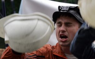 Miner knocks by helmet