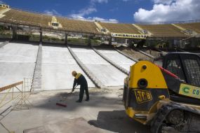 A worker wipes off the buildings offcuts