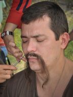 A make-up artist remedies moustaches to the actor
