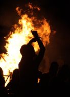 Children dance near a fire