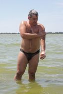The habitant of Evpatoria washes in a lake