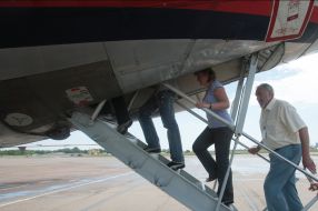 The employees of air-port walk up the side of airplane