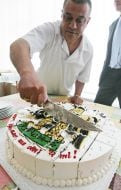 A waiter cuts a cake