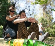 A girl-pank does a hair-do (mohawk) to the friend