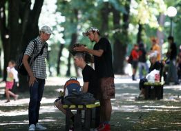 Young man does a hair-do (mohawk) to the friend