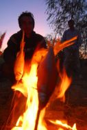 Participant of the expedition cooks fish