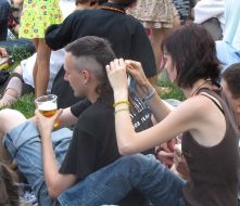 Girl braids a pigtail to the fellow