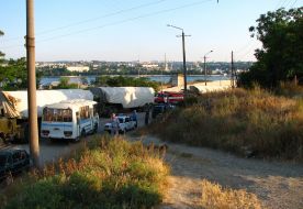 The traffic police cars stand near the Black sea Fleet of Russian Federation trucks column