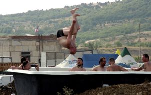 People bathing in large bath