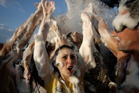 Young people dances in soap-suds