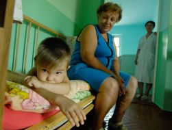 Boy, patient by tuberculosis, lies on bed