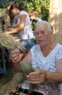 A woman makes a grass doll
