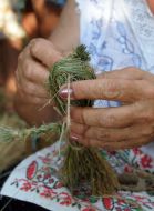 A woman makes a grass doll