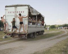 The participants of festival  ride in a truck