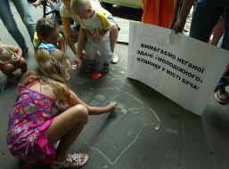 Children draw on an asphalt