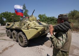 A serviceman controls фrmoured personnel carries column motion