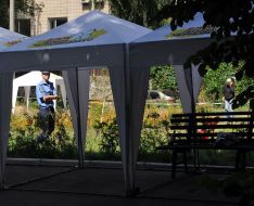 Militiaman goes near the tents of Block of Leonid Chernovetskiy