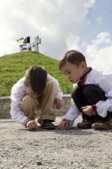 Children sit near burial Mound the ”Cossack grave”
