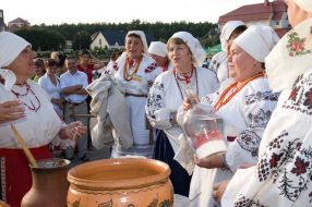 Festival participant pours out the home-distilled vodka