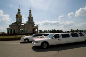 Weddings limousines near a church