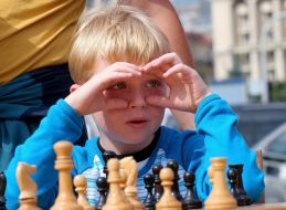 A boy plays chess