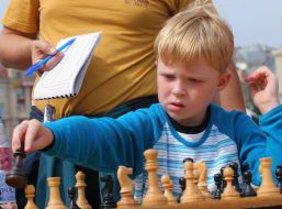 A boy plays chess
