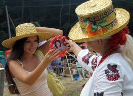 A girl tries on a straw hat