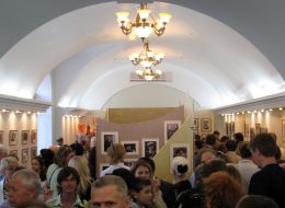 Visitors examine pictures