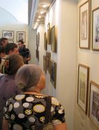 Visitors examine pictures