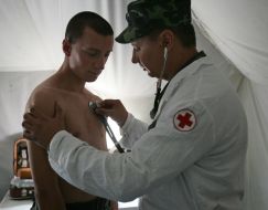 A military doctor render aid to the ”sick refugee”