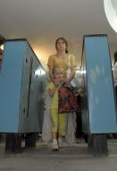 A mother with child going cross a turnstile