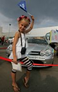 Gilr stands near the car of Merecedes-Benz